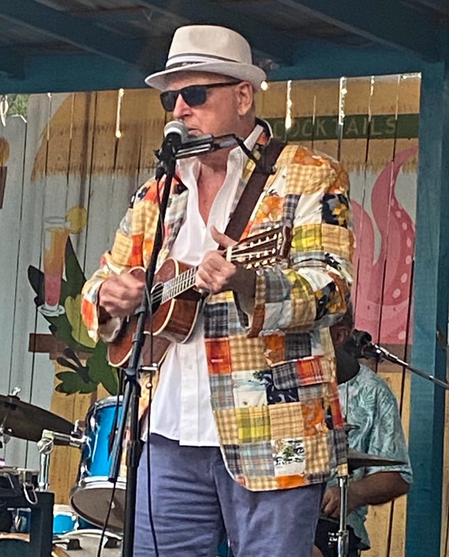 Tom Hood of Lex & Hood singing and playing ukulele on stage